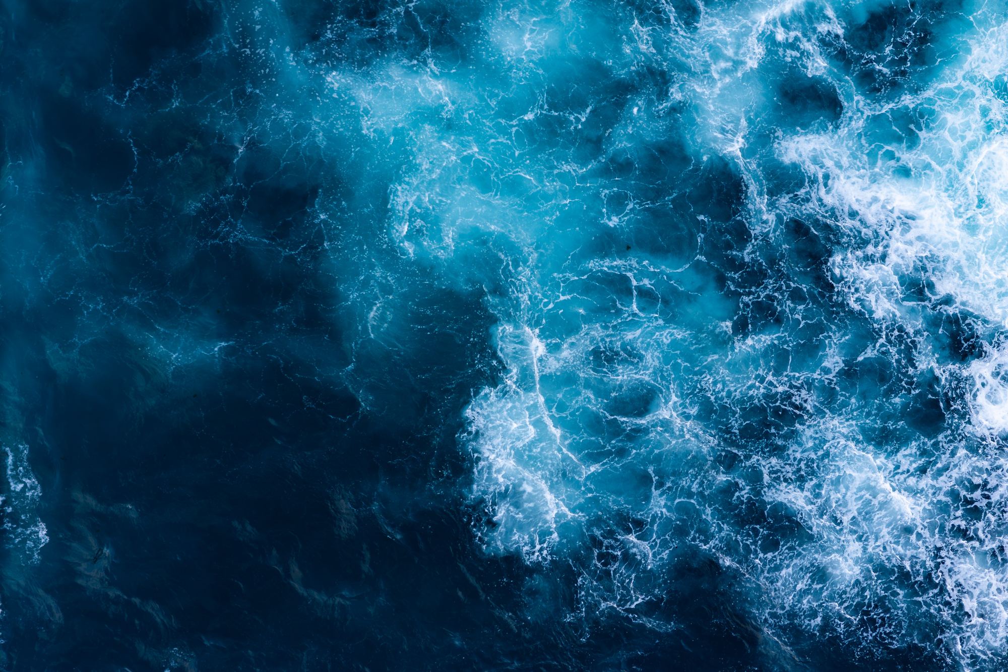 Waves breaking on open ocean, seen from above